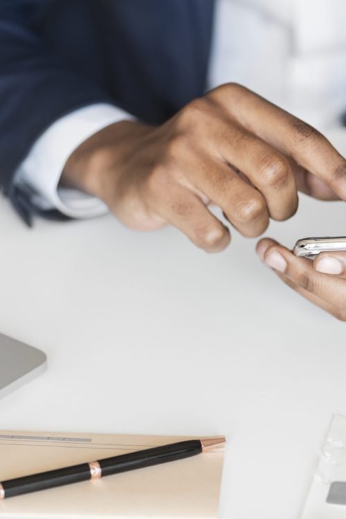 Closeup of businessman using mobile phone